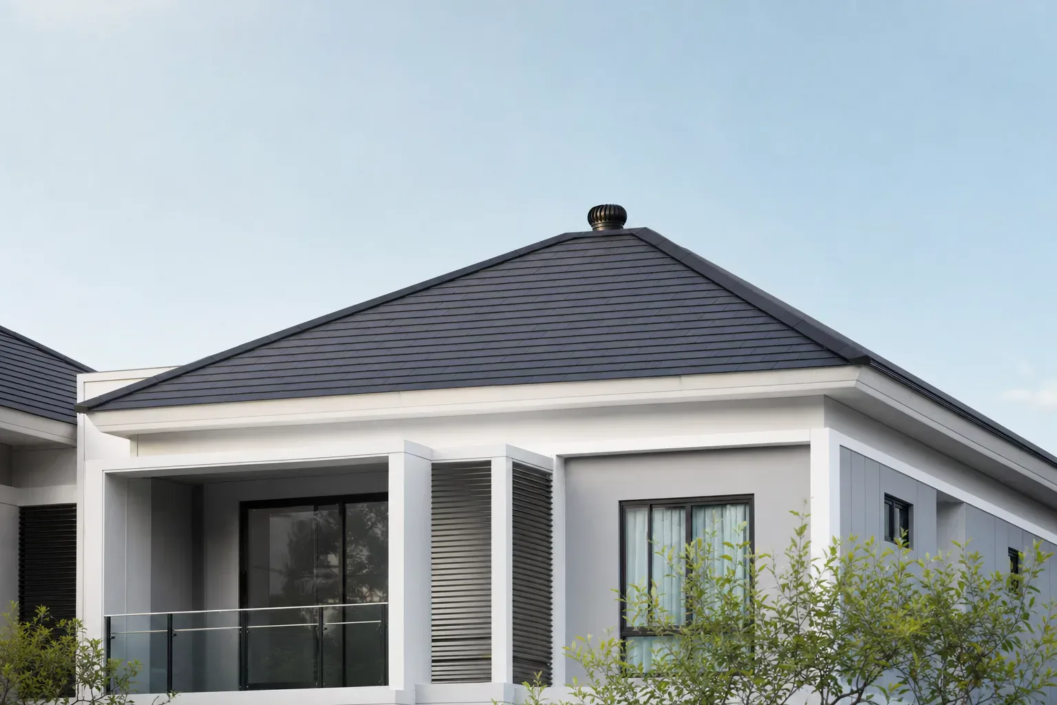 Modern home roof with a wind-driven ventilator.